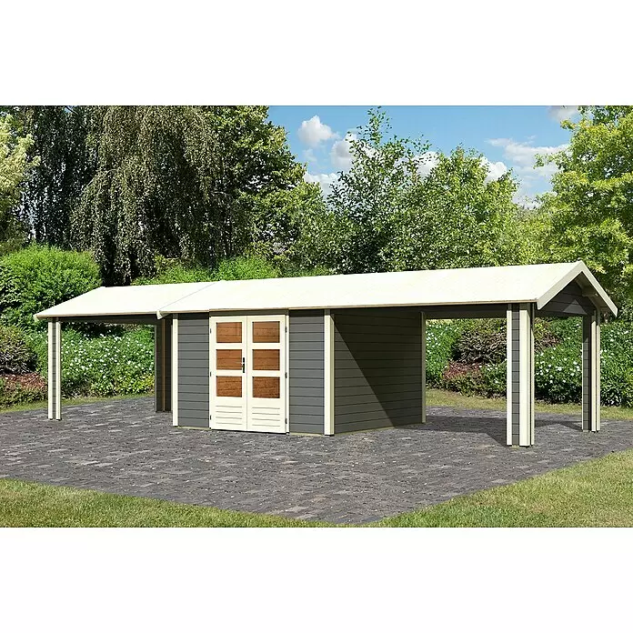 Karibu Gartenhaus Theres - Außenmaß inkl. Dachüberstand (B x T): 947 x 348 cm, Holz, Terragrau - Dunkelgrauer Gartenschuppen mit cremefarbenen Zierleisten und Türen, mit breiten Carport-Erweiterungen und hellem Dach auf gepflasterter Terrasse.