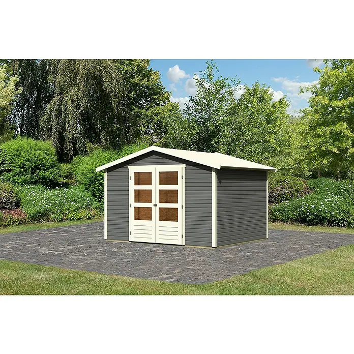 Karibu Gartenhaus Amberg 4Außenmaß inkl. Dachüberstand (B x T): 272 x 282 cm, Holz, Terragrau - Ein graues Gartenhaus mit Doppeltür und weißem Rahmen steht auf einem gepflasterten Bereich, umgeben von Grün.
