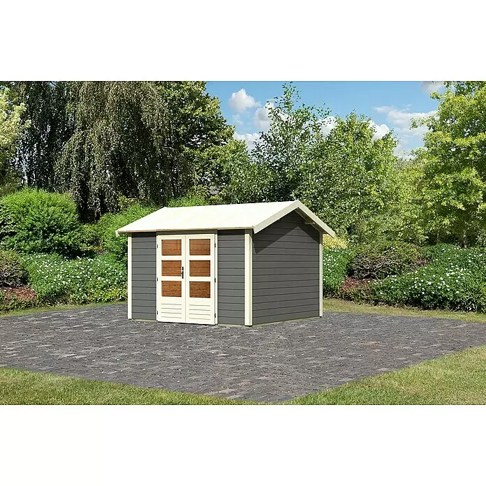 Karibu Gartenhaus Theres - Außenmaß inkl. Dachüberstand (B x T): 337 x 348 cm, Holz, Terragrau - Grauer Gartenschuppen mit cremefarbenen Akzenten und Türen mit Holzpanelen, auf gepflastertem Bereich im Garten.