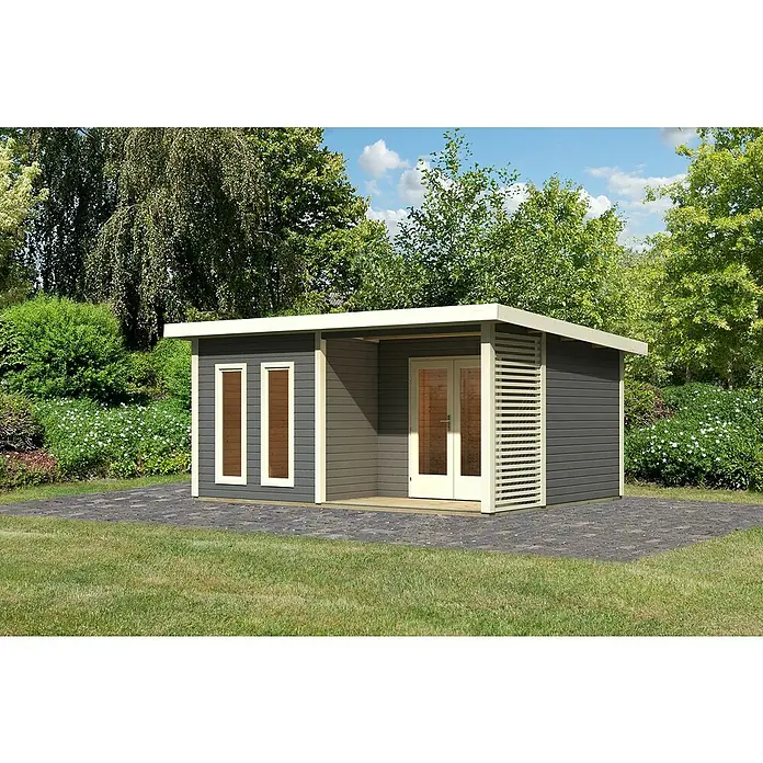 Karibu Gartenhaus Radeburg 5 - Außenmaß inkl. Dachüberstand (B x T): 560 x 422 cm, Holz, Terragrau - Das Bild zeigt ein modernes Gartenhaus mit grauen Wänden, weißen Rahmen und einem flachen Dach, umgeben von Grünflächen und Bäumen.