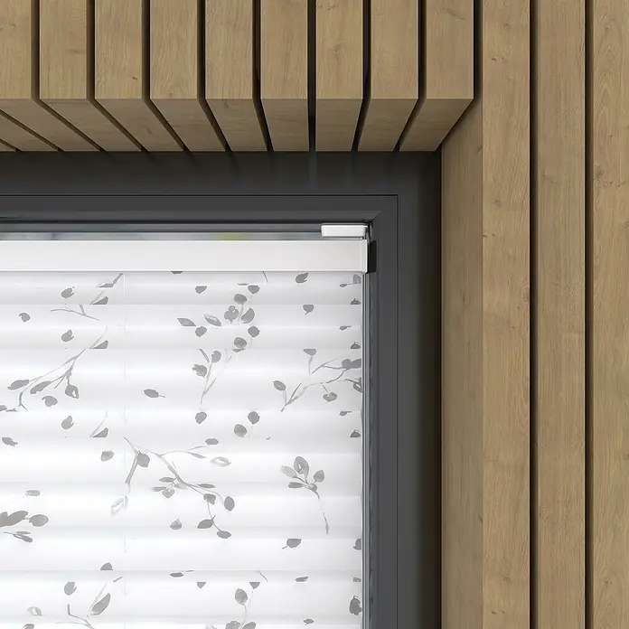 Expo Ambiente Plissee - B x H: 80 x 130 cm, Grau/Weiß - Nahaufnahme einer weißen Fensterjalousie mit grauem Pflanzenmuster in einem modern gestalteten Raum mit Holzverkleidung.