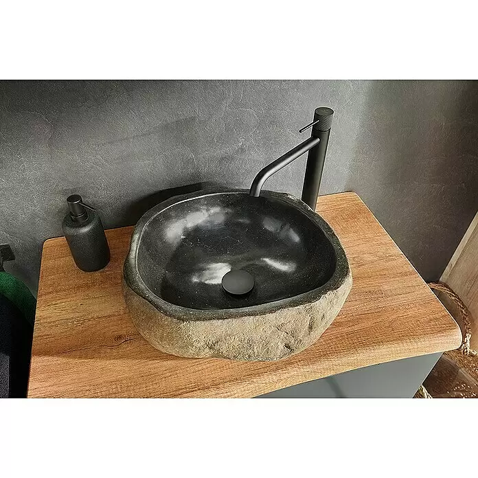 Astor Tree Aufsatzwaschbecken - B x L: 55 x 43 cm, Flussstein, Naturstein - Dunkles Steinwaschbecken mit matt-schwarzem Wasserhahn und Seifenspender auf Holzplatte.