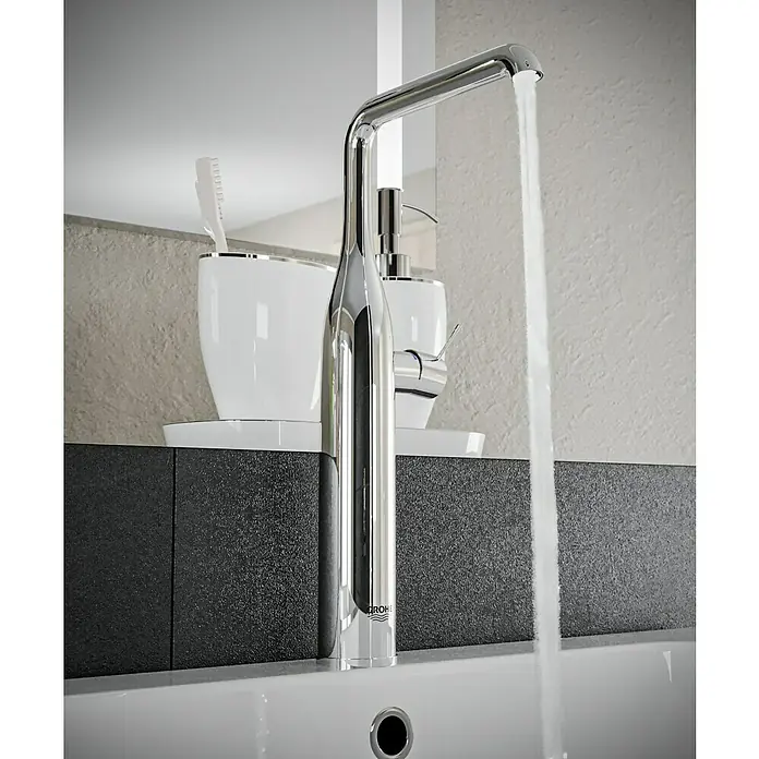 Grohe Essence Waschtischarmatur XL-Size - Chrom, Glänzend - Ein glänzender, moderner Wasserhahn der Marke Grohe mit fließendem Wasser in einem stilvollen Badezimmer.