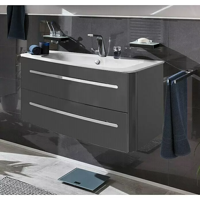 Lanzet Classico Waschtischunterschrank - 99,2 x 52,4 x 48,2 cm, Grafit, Chrom, Links - Dunkelgrauer wandhängender Badunterschrank mit weißem Waschbecken, zwei Schubladen und silbernen Griffen im modernen Bad.