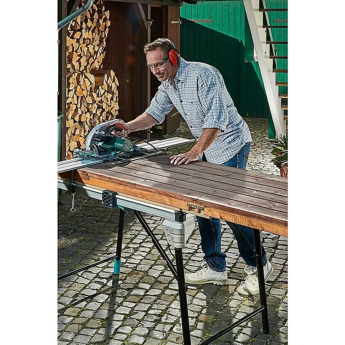 Wisent Auriculares de protección - Rojo/Negro - Hombre serrando con sierra circular en banco de trabajo Wolfcraft Master Work 1600.