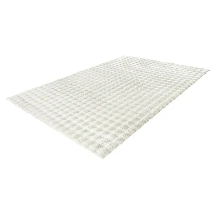 Hochflorteppich Harmony - Ivory, 170 x 120 cm, 100 % Polyester (Flor) - Nahaufnahme einer weißen Badematte mit Waffelmuster, die Weichheit und Saugfähigkeit für den Komfort nach dem Duschen bietet.