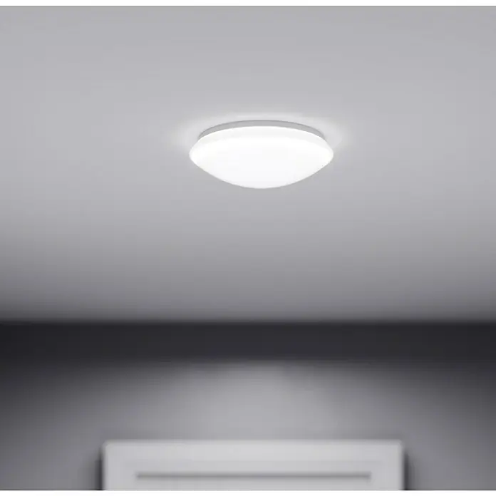 Steinel LED-Sensor-Deckenleuchte RS 16 LED S GLAS WW - 9,3 W, Weiß - Nahaufnahme einer runden, weißen Deckenleuchte, die sanftes Licht in einem modernen Raum verbreitet. Schlichtes Design für stilvolle Beleuchtung.