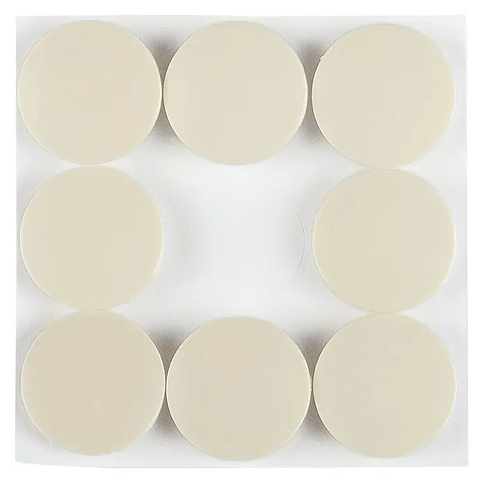 Stabilit Teppichgleiter - 22 mm, Weiß, 8 Stk., Kleben - Das Bild zeigt runde, beigefarbene Möbelgleiter auf einer transparenten Trägerfolie, ideal zum Schutz von Böden vor Kratzern.