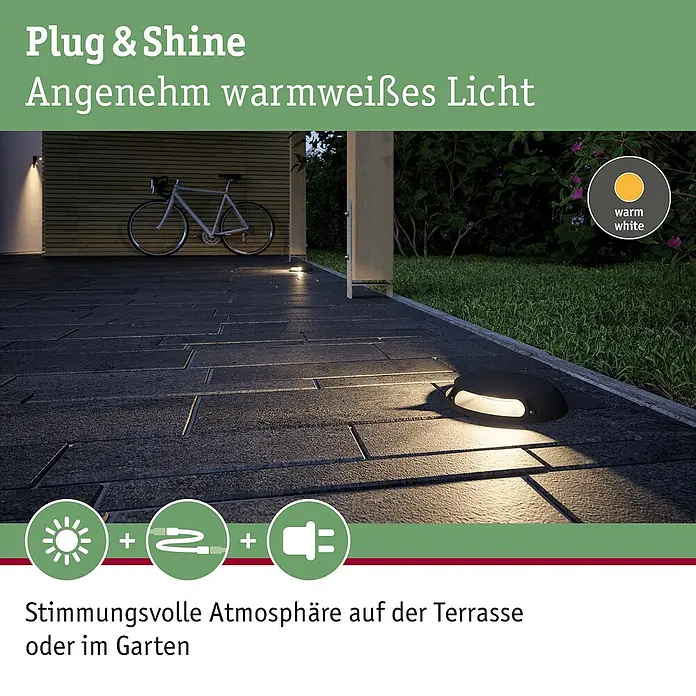 Paulmann Plug & Shine LED-Außenleuchte - 6 W, Warmweiß, IP67, Ø x H: 16 x 3,2 cm - Das Bild zeigt eine moderne Plug & Shine-Beleuchtung, die warmweißes Licht spendet und eine stimmungsvolle Atmosphäre im Garten erzeugt.