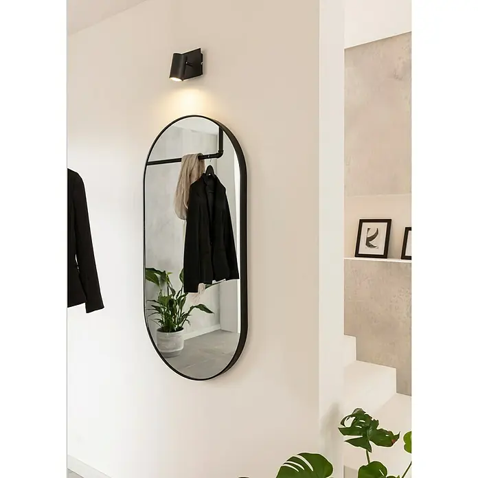 Rahmenspiegel Malva - 60 x 120 cm, Schwarz - Dieser Flur zeigt einen ovalen Spiegel mit schwarzem Rahmen, eine Garderobenstange und eine schicke Wandleuchte.
