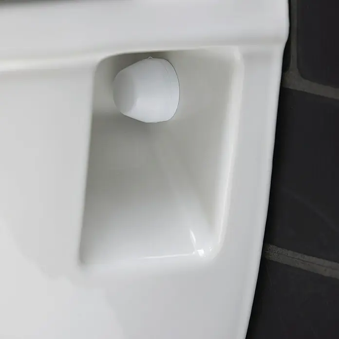 Duravit DuraStyle Wand-WC-Set Compact - Spülrandlos, Ohne Spezialglasur, Spülform: Tief, WC Abgang: Waagerecht, Weiß - Nahaufnahme eines weißen Toilettendeckels mit einem weißen Stopper.