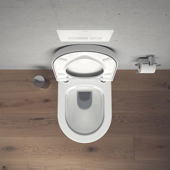 Duravit Starck 3 Wand-WC-Set - Spülrandlos, Mit antibakterieller Glasur, Spülform: Tief, WC Abgang: Waagerecht, Weiß - Blick von oben auf eine moderne, wandhängende Toilette mit offenem Sitz in einem Badezimmer mit Holzboden und Betonwand.