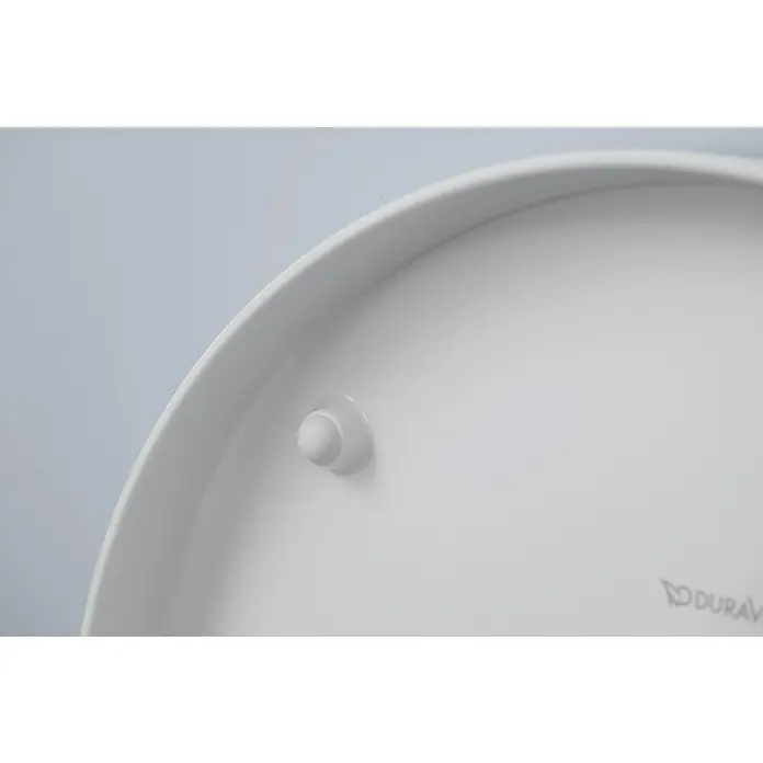 Duravit ME by Starck Wand-WC-Set Typ 1 - Spülrandlos, Ohne Spezialglasur, Spülform: Tief, WC Abgang: Waagerecht, Weiß - Detailaufnahme eines Duravit-Produkts, das eine glatte, weiße Oberfläche und einen kleinen, runden Stopper zeigt. Die minimalistische Ästhetik unterstreicht die hochwertige Verarbeitung.