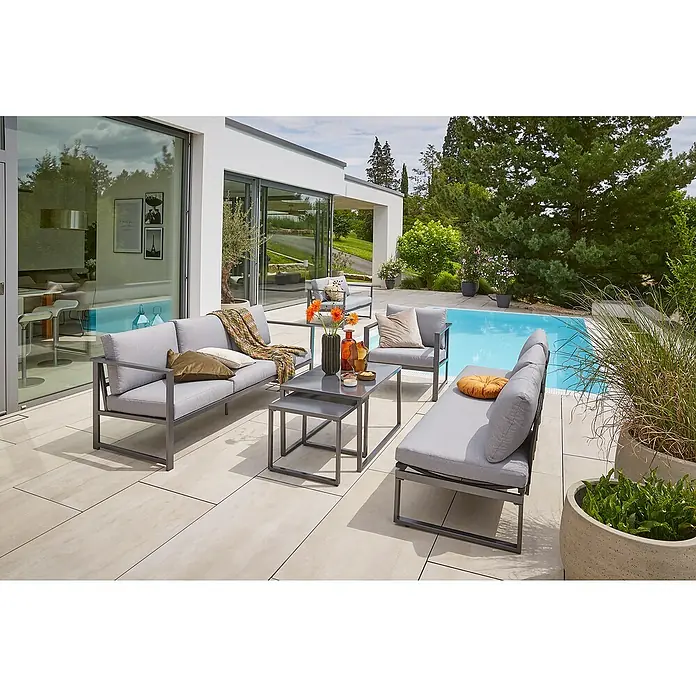Sunfun Maja Slim Garten-Couchtisch - L x B x H: 50 x 50 x 43 cm, Anthrazit - Moderne graue Gartenmöbelgruppe mit Sofas, Sesseln und Tischen auf einer Terrasse neben einem Pool. Elegantes Design für den Außenbereich.