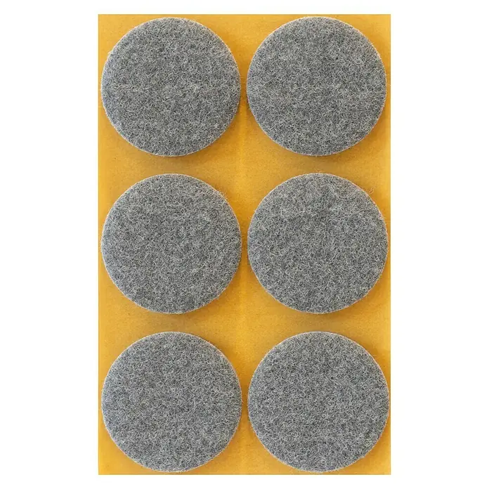 Stabilit Filzgleiter - Durchmesser: 45 mm, Grau, Kleben, 6 Stk. - Sechs graue Filzgleiter zum Schutz von Möbeln, angeordnet auf einer gelben Unterlage, ideal zum Vermeiden von Kratzern auf Böden.