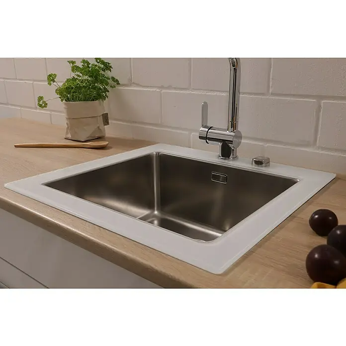 Respekta Einbauspüle New York - 55 x 53 cm, Edelstahl, Weiß - Edelstahlspüle mit schlankem Chromhahn auf einer hellen Arbeitsplatte, die moderne Küche betont. Kräutertopf und Pflaumen zur Dekoration.