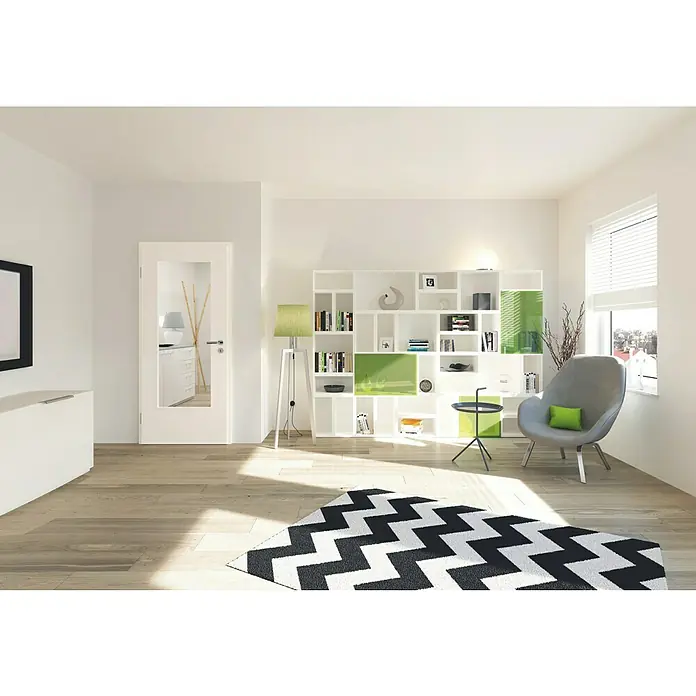 GetaDoor Laminit Zimmertür GL 222 LA - 735 x 1.985 mm, DIN Anschlag: Links, Arctic Weiß, Röhrenspan - Helles Wohnzimmer mit einem modernen, weißen Bücherregal, einem grauen Sessel und einem schwarz-weißen Zickzack-Teppich.