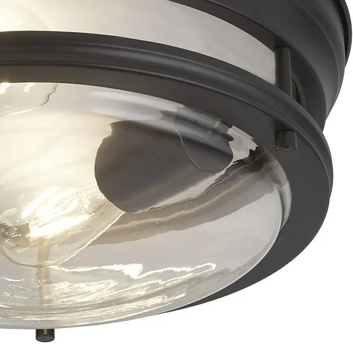 Searchlight Deckenleuchte rund Glasgow - 120 W, Ø x H: 35 x 14,5 cm, Schwarz, E27 - Nahaufnahme einer Deckenleuchte mit einem Rahmen in Bronze und klarem Glas, die ein warmes Licht ausstrahlt.