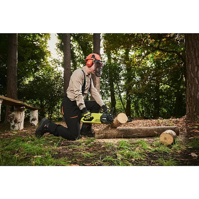 Ryobi ONE+HP Akku-Kettensäge RY18CSX30A-0 - 18 V, Li-Ionen, Ohne Akku, Schwertlänge: 30 cm - Ein Mann benutzt eine RYOBI Akku-Kettensäge, um Brennholz im Wald zu schneiden. Sicherheitsausrüstung wird getragen.