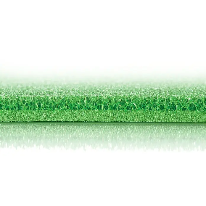Tescoma Kühlschrankmatte 4 FoodGrün - Nahaufnahme eines grünen Reinigungsschwamms mit rauer Textur, ideal für die gründliche Reinigung im Haushalt.