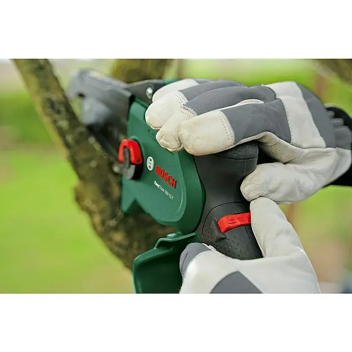 Bosch Power for All 18V Akku-Kettensäge EasyChain 18V-15-7 - 18 V, Li-Ionen, 1 Akku, Schwertlänge: 15 cm - Nahaufnahme einer Bosch EasyChain 18V-15-7 Akku-Kettensäge in Aktion, bedient mit behandschuhten Händen.