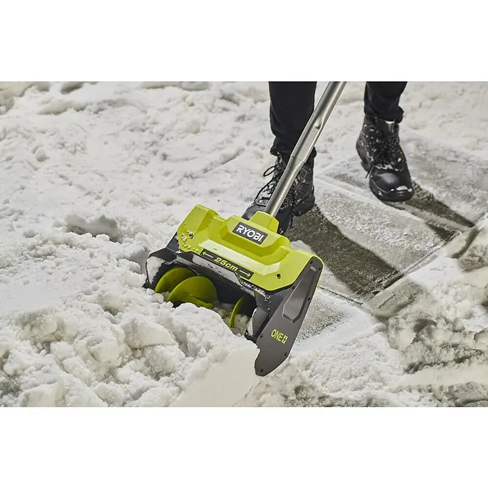 Ryobi ONE+ Akku-Schneefräse RY18ST25A-0 - 18 V, Ohne Akku, Arbeitsbreite: 25 cm - Eine RYOBI Schneefräse im Einsatz, die Schnee räumt. Das Gerät ist grün-schwarz und wird von einer Person in Stiefeln bedient.