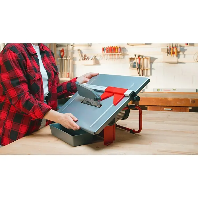 Herkules Elektro-Fliesenschneider H-FS 900 - 900 W, Schnitttiefe bei 90 °: 41 mm - Eine Person, die eine Hekules Tischkreissäge benutzt, um präzise Schnitte in einem Werkstattumfeld durchzuführen.