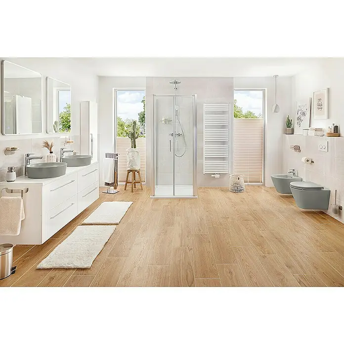 RAK Ceramics Feeling Wand-Bidet - 36 x 52 cm, Grau, Keramik, Ohne Spezialglasur - Das Badezimmer verfügt über einen Doppelwaschtisch mit grauen Waschbecken, eine Duschkabine und eine Toilette mit Bidet in einem hellen, modernen Design.
