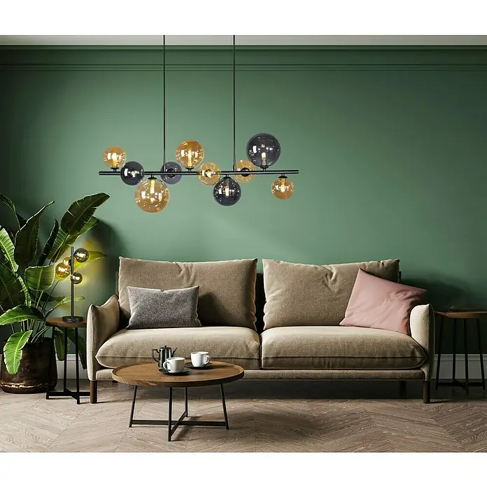 Paul Neuhaus Popsicle Tischleuchte - 12 W, L x B x H: 24 x 24 x 48 cm, Schwarz, G9 - Elegante Wohnzimmeransicht mit einem stilvollen Sofa, einem Couchtisch und einer dekorativen Kugelleuchte, die dem Raum eine moderne Note verleiht.
