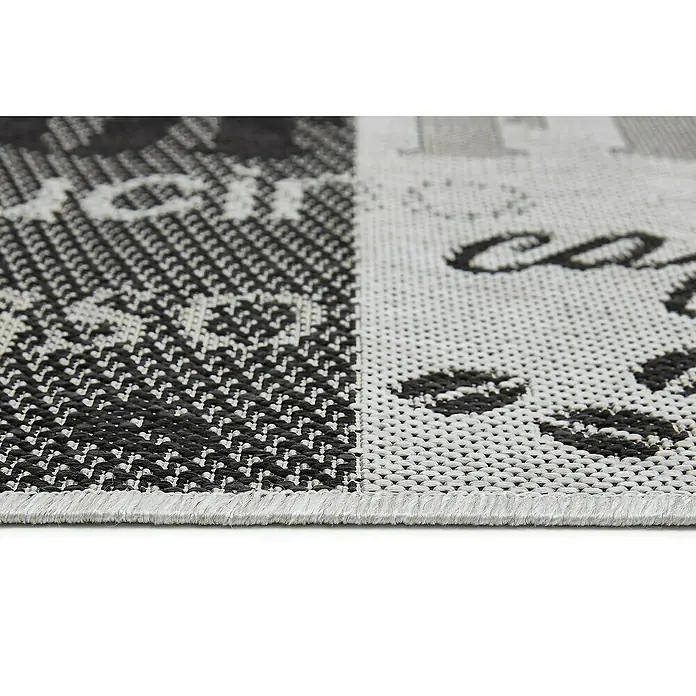 Teppichläufer Arizona - Grau, 150 x 50 cm, 100 % Polypropylen - Detailaufnahme eines Teppichs mit Kaffeemotiv, der durch seine schwarz-weiße Farbgebung und das markante Muster auffällt.