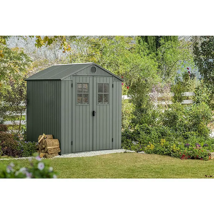 Keter Gartenhaus Darwin 6x6 - Außenmaß inkl. Dachüberstand (B x T): 190 x 183 cm, Kunststoff, Grün, 3,477 m² - Eine graue Gerätehütte mit Doppeltür und Fenstern im Garten. Das Gartenhaus bietet Stauraum und fügt sich gut in die grüne Umgebung ein.