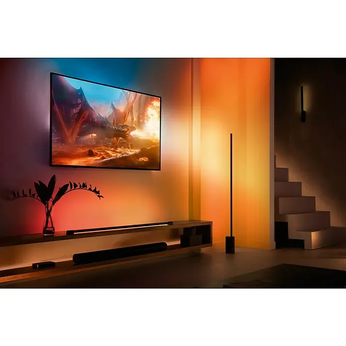 Philips Hue LED-Band Plus Basis - 2 m, RGBW - Das Bild zeigt einen modernen Wohnraum mit einem Philips Ambilight Fernseher, der ein beeindruckendes visuelles Erlebnis bietet.