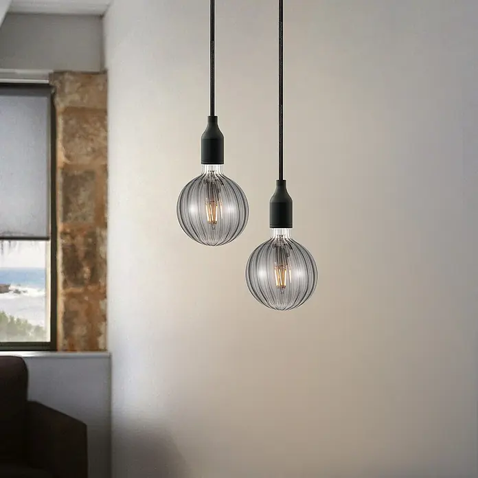 Home Sweet Home LED-Lampe Filament Classic Vintage Globe-Form gestreift - E27, Dimmbar, Warmweiß, 140 lm, 4 W - Zwei hängende rauchgraue Glühbirnen mit gewirbelter Oberfläche, die ein warmes Licht ausstrahlen und eine moderne Note verleihen.