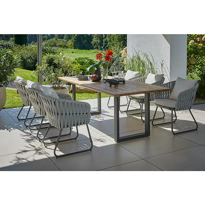 Sunfun Maja Gartenmöbel-Set - 8 -tlg., Teak/Edelstahl/Seilgeflecht, Teak/Grau/Beige, Schweizer-Kante/U-Gestell - Einladende Gartenszene mit einem Esstisch aus Holz und sechs eleganten Sesseln mit grauer Seilbespannung, ideal für Mahlzeiten im Freien.