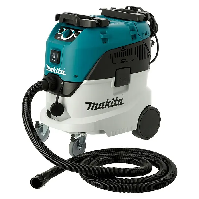 Makita Elektro-Nass- & Trockensauger VC4210M - 1.200 W, Behältervolumen: 42 l, Mit Beutel - Das Bild zeigt einen Makita-Industriestaubsauger in Türkis, Schwarz und Weiß mit Schlauch und Rollen.