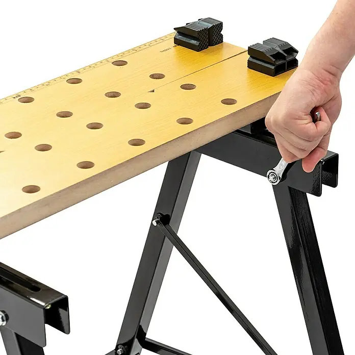 Alpha Tools Ringmaulschlüssel-Satz - Schlüsselweite: 6 mm - 32 mm - Bild einer Werkbank mit Holzarbeitsfläche, schwarzen Beinen und einer Hand, die einen Knopf bedient.\n