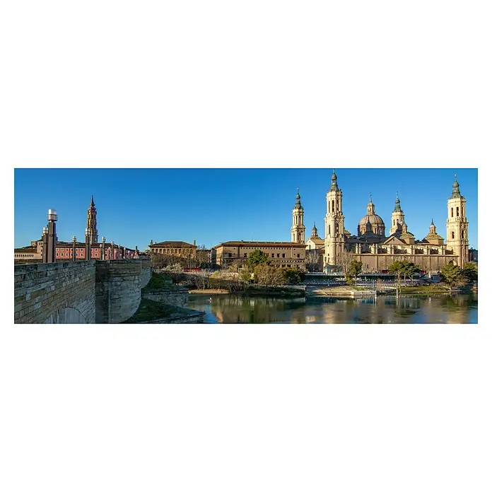 Cuadro Catedral Pilardia - Catedral Pilardia, An x Al: 120 x 40 cm, 1 pzs. - Vista de la Basílica de Nuestra Señora del Pilar y el río Ebro en Zaragoza, España, con cielo azul.