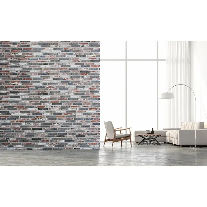 Celina Klinker Verblendstein Vintage Malmö - 5,2 x 24 cm, Beige/Grau, Steinoptik - Ein helles Wohnzimmer mit einer gemusterten Backsteinwand, einem bequemen Sofa und einem modernen Sessel, die ein gemütliches Ambiente schaffen.
