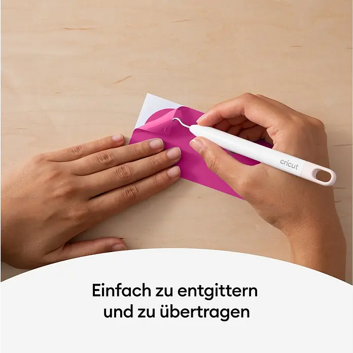 Cricut Vinylfolie Color Change Hot Permanent - 1 Stk., Pink/Rosa, 30 x 60 cm - Nahaufnahme eines Cricut Werkzeugs beim Entgittern von rosafarbenem Vinyl auf einem hellen Holztisch.