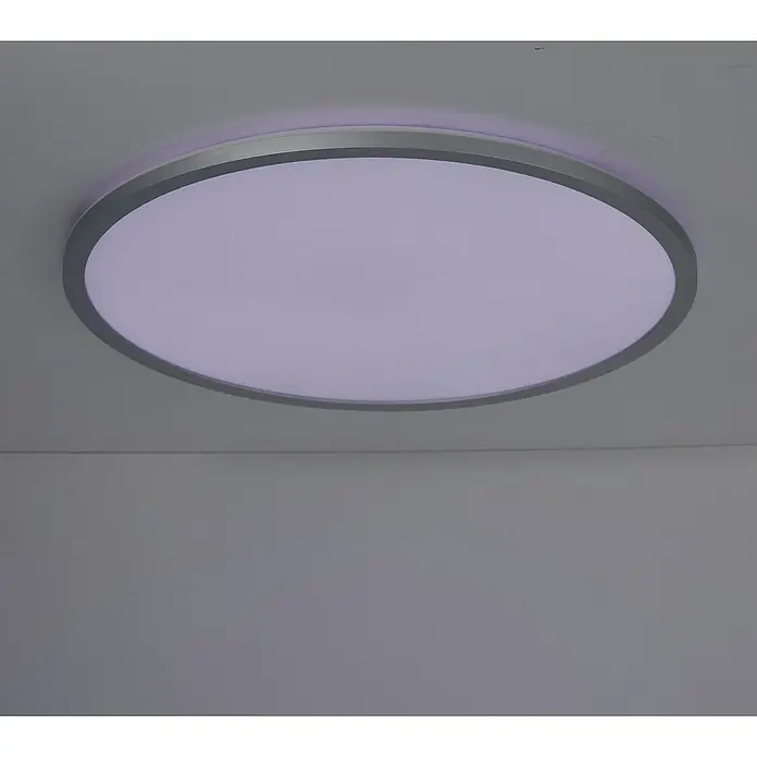 Brilliant LED-Deckenleuchte rund Tanida - 46 W, Ø x H: 57 x 3,2 cm, Silber, RGBW - Nahaufnahme einer modernen, runden Deckenleuchte mit einem silbernen Rahmen und sanftem violettem Licht.