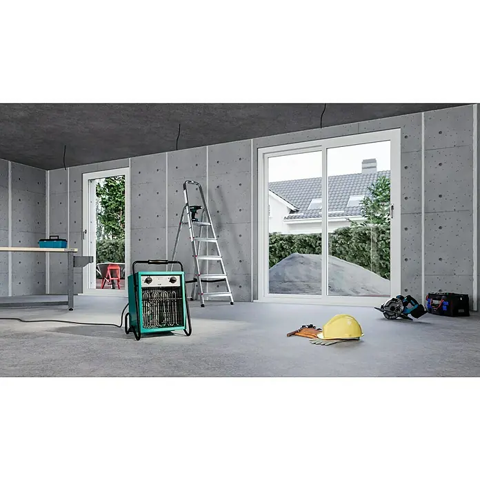 Voltomat HEATING Bauheizer - 4.500 W - 9.000 W, Nennspannung: 400 V, Grün/Schwarz, IP24 - Eine Innenaufnahme einer Baustelle mit Betonwänden, Werkzeugen und einer elektrischen Heizung, die auf dem Boden steht.