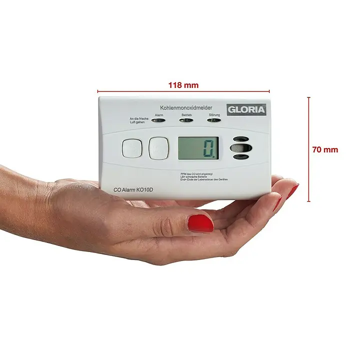 Gloria Kohlenmonoxidmelder KO10D - L x B x H: 116 x 72 x 40 mm, Batterielaufzeit: 10 Jahre - Das Bild zeigt einen Kohlenmonoxidmelder von GLORIA, Modell KO10D, mit den Abmessungen 118 mm x 70 mm. Er wird in einer Hand gehalten.