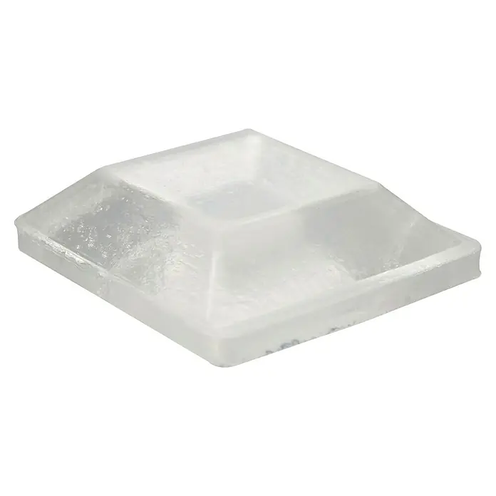 Wagner System Plastik-Gleiter - Transparent, L x B x H: 12,7 x 12,7 x 3 mm - Nahaufnahme eines quadratischen Möbelgleiters aus transparentem Kunststoff mit einer Stufenform, ideal für den Schutz von Fußböden.