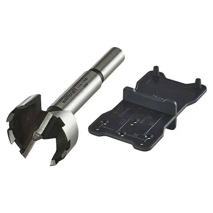 Wolfcraft Forstnerbohrer-Set - 2 -tlg., Durchmesser Schaft: 10 mm - Forstnerbohrer mit Positionierlehre. Das Set besteht aus einem Forstnerbohrer und einer schwarzen Positionierlehre mit Bohrlöchern in verschiedenen Größen.