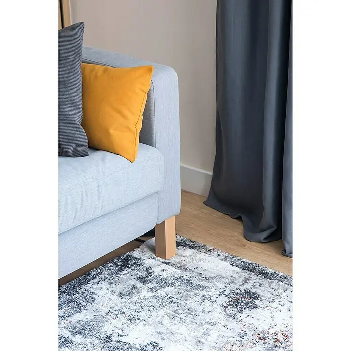 Cortinas Jodie - An x Al: 140 x 250 cm, Gris, Plástico - Primer plano de un sofá gris claro con cojines vibrantes y una alfombra moderna, acentuado por cortinas grises al fondo.
