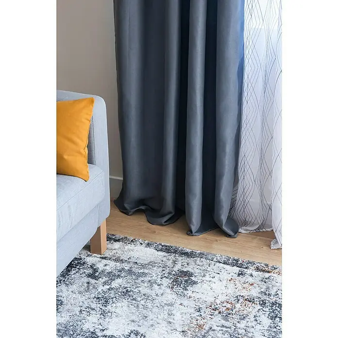 Cortinas Jodie - An x Al: 140 x 250 cm, Gris, Plástico - Vista detallada de una sala de estar con cortinas grises que tocan elegantemente el suelo y un sofá a juego con un cojín amarillo.