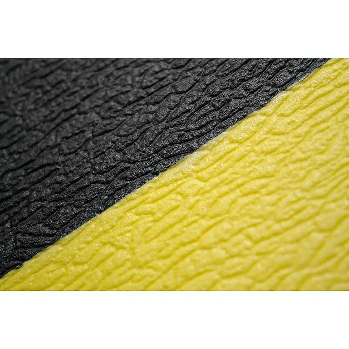 Coba Anti-Ermüdungsmatte Orthomat®-Standard Safety - Breite: 90 cm, Schwarz / Gelb - Detailaufnahme einer strukturierten Oberfläche in Schwarz und Gelb, die eine interessante Textur und Farbkombination zeigt.