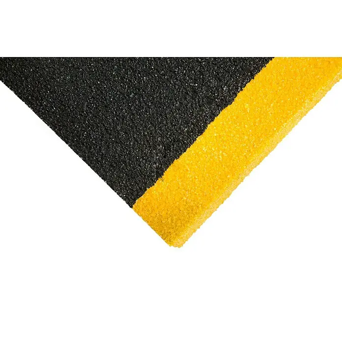Coba Stufenmatte Grip® Stair Tread - Breite: 100 cm, Schwarz/Gelb - Detailaufnahme einer schwarzen Antirutschmatte mit gelbem Rand. Das Produkt sorgt für mehr Sicherheit und Haftung auf glatten Oberflächen.