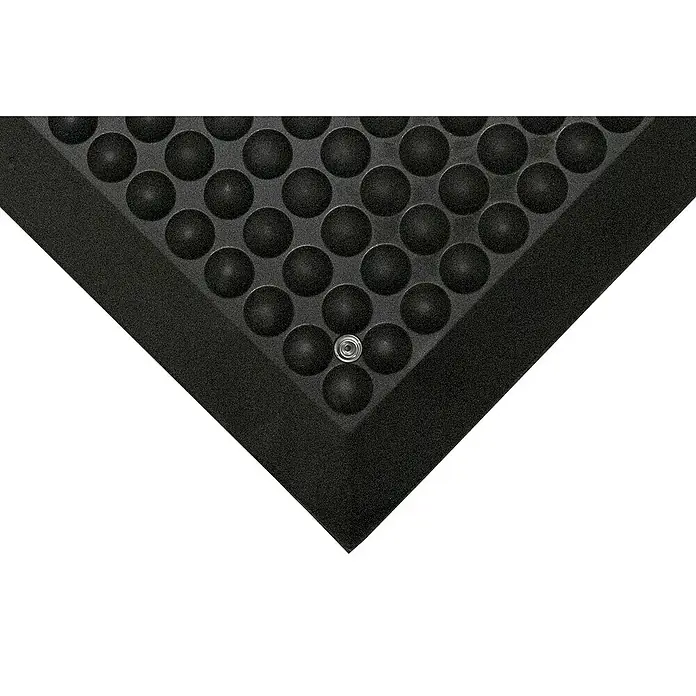 Coba Anti-Ermüdungsmatte Elite® ESD - 90 x 120 cm, Einsatzbereich: Elektrobetriebe - Ausschnitt einer schwarzen Anti-Ermüdungsmatte mit Noppen und einer Befestigung, ideal für den Arbeitsplatz, um Komfort und Sicherheit zu gewährleisten.