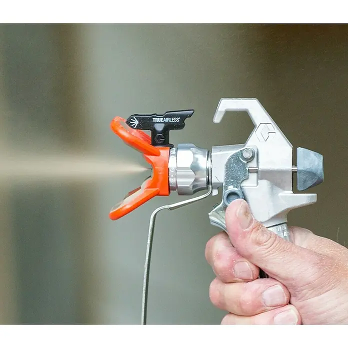 Graco Magnum Juego de recambio FlexLiner - Específico para: Graco Magnum Sistema de pulverización Compact A5DS - Primer plano de un pulverizador de pintura TrueAirless, rociando pintura y sostenido por una mano.